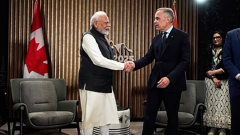 India's Prime Minister Narendra Modi, left, and Canada's Prime Minister Mark Carney shake hands