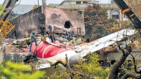 Cranes clearing the debris of the crashed Air India plane in Ahmedabad