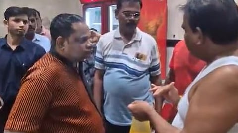 Shiv Sena MLA Sanjay Gaikwad , scolding the manager, forcing him to smell stale dal and rice.
