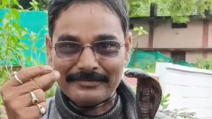 Madhya Pradesh man rides bike with cobra wrapped around neck