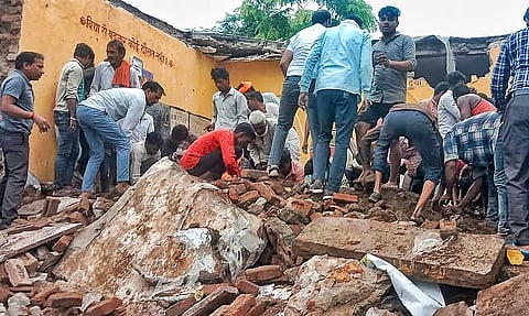 Locals during the rescue work after a government school building collapsed, in Jhalawar district, Rajasthan, Friday, July 25, 2025