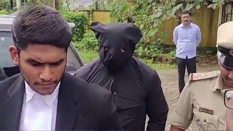 Witness complainant being taken to an alleged burial site near Nethravathi bathing ghat amid tight police security on Monday