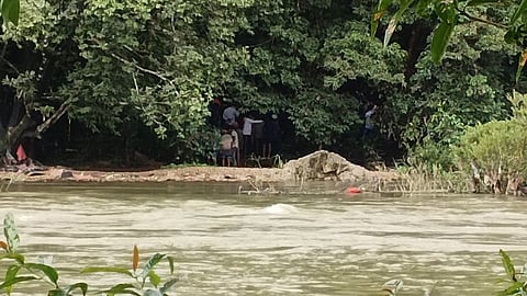 Curious onlookers gather at a bridge across the Nethravathi river