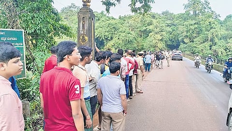 Curious onlookers gather at a bridge across the Nethravathi river