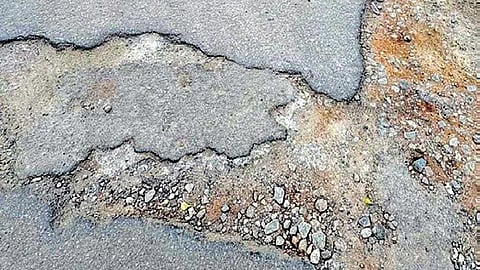 Potholes on a road at Hemmigepura near Kanakapura Road