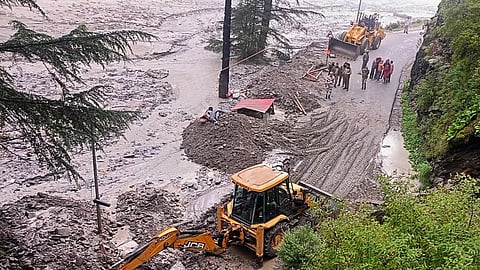 An excavator being used to clear debris from a road following flash floods triggered by a cloudburst, near Harsil in Uttarkashi district, Uttarakhand