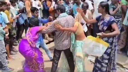 Womens holding their hair and beating each other in the market
