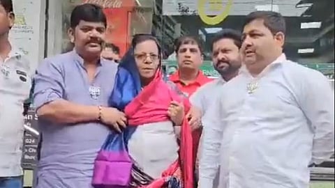 BJP workers make Congress functionary Prakash Pagare to wear a saree over his post on PM Narendra Modi.