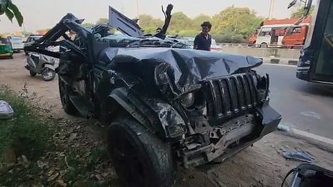 Police personnel look on as wreckage of a Thar being towed away after an accident