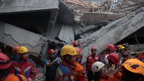 Rescuers search for victims at the site where a building under construction collapsed at an Islamic boarding school in Sidoarjo, East Java, Indonesia