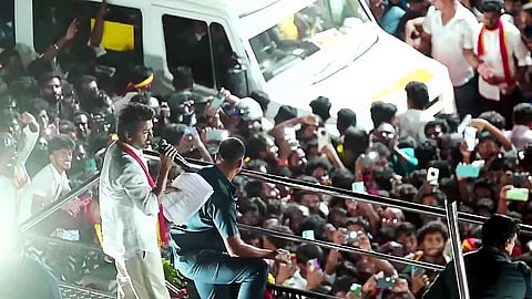 In this image from Sep. 27, 2025, Tamilaga Vettri Kazhagam chief and actor Vijay addresses a gathering before a stampede during a public event, in Karur.