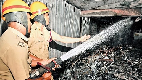 Firefighters try to douse fire gutted inside a godown in Bengaluru on Thursday