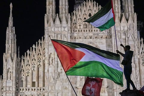 Pro-Palestinian demonstrators wave Palestinian flags in front of Milan's Duomo Gothic Cathedral in northern Italy, Thursday