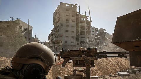 Israeli army shows an Israeli army soldier behind a mounted machine gun in the vicinity of the Jordanian Field Hospital in Gaza City