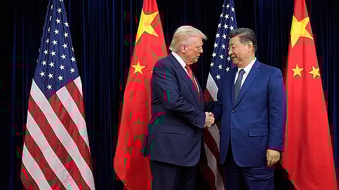 President Donald Trump, left, and Chinese President Xi Jinping shake hands before their meeting at Gimhae International Airport in Busan, South Korea.