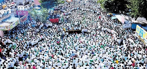 A large gathering of sugarcane farmers stages an indefinite protest in Gurlapur, near Belagavi, on Tuesday.