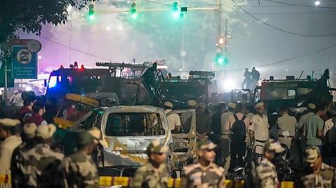 Security personnel at the spot after a blast occurred in a parked car near Red Fort, leaving multiple vehicles in flames, in New Delhi, Monday