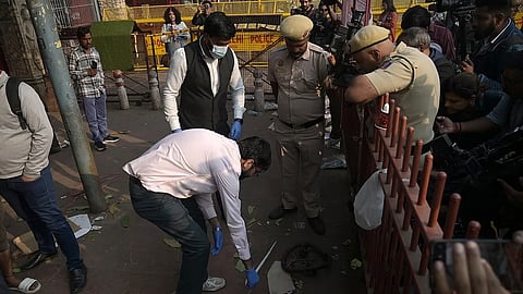 Forensic official collects samples from the site in the aftermath of the blast that occurred near Red Fort Metro Station on Monday, killing at least 12 people.