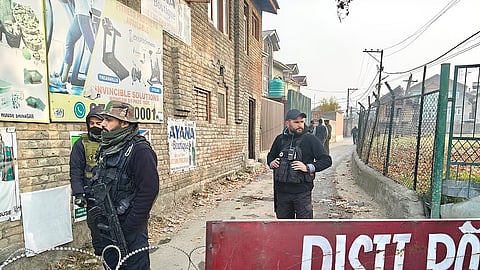 Police seal the area around Nowgam police station after a midnight explosion