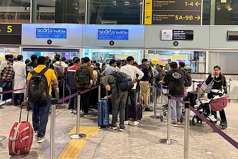 Travelers waiting in queues at IndiGo ticketing kiosks to reschedule their flights at Kempegowda International Airport in Bengaluru.
