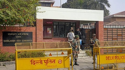 Security personnel stand guard outside the Bangladesh High Commission in view of the recent unrest in the country, in New Delhi.
