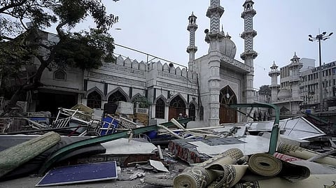 Debris and belongings lie outside the Syed Faiz Elahi mosque
