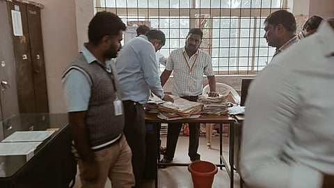 Lokayukta police personnel inspect documents during a raid at an office in Nagamangala taluk, Mandya district, on January 14, 2026.