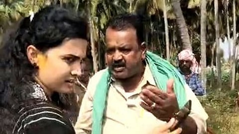 Varuna Hobli's Gudamadanahalli village resident GM Puttaswamy threatening officers Bhavya and Naveen Kumar during agriculture land survey.