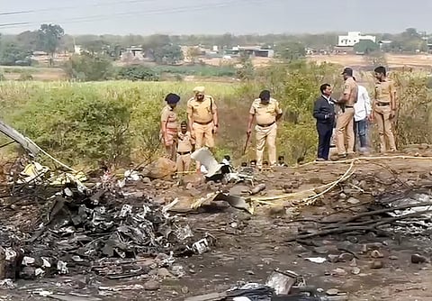 Police officials at the spot after an aircraft carrying Maharashtra Deputy Chief Minister Ajit Pawar crashed during landing, near Baramati.