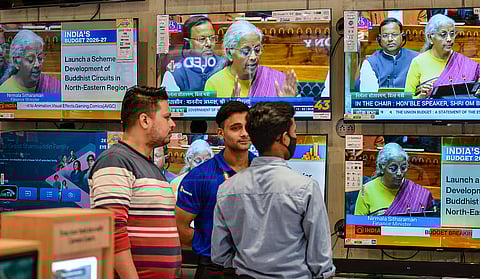 People watch the presentation of the Union Budget 2026-27 