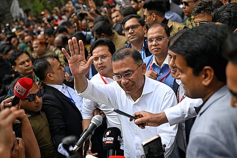 Bangladesh Nationalist Party Chairperson Tarique Rahman waves as he comes out after casting his vote during the national parliamentary elections in Dhaka, Bangladesh