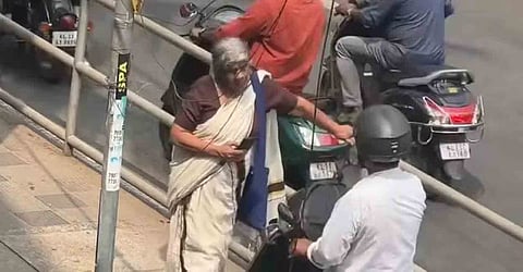 elderly woman forces scooter rider off footpath in Kozhikode