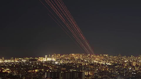 Tracer rounds light the sky as people fire live rounds into the air during a televised speech by Hezbollah leader