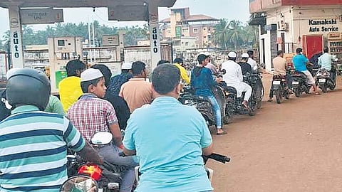Motorists queue up in front of a petrol station in Gadag