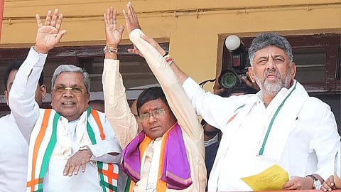 Congress candidate for Bagalkot bypoll Umesh Meti flanked by CM Siddaramaiah and DCM DK Shivakumar after filing his papers on Monday.