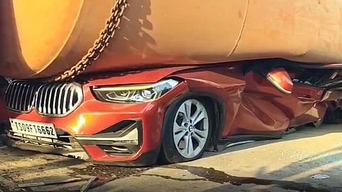 lorry carrying fly ash overturned on a BMW car