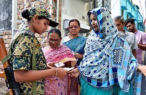 Security check underway at a polling station during voting in the first phase of the West Bengal Assembly elections, in Murshidabad