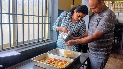 Vishwakeshava and Navyashri Kuruveri from Kasargod making cashew apple pulp 
