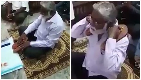 ಚಪ್ಪಲಿ ಮೈ ಮೇಲೆ ಸವರಿಕೊಳ್ಳುತ್ತಿರುವ  ಸಚಿವ ಮಹೇಶ್