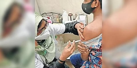 ಆರೋಗ್ಯ ಕಾರ್ಯಕರ್ತೆಯೊಬ್ಬರು ವ್ಯಕ್ತಿಯೊಬ್ಬನಿಗೆ ಕೋವಿಡ್-19 ಲಸಿಕೆ ನೀಡುತ್ತಿರುವುದು