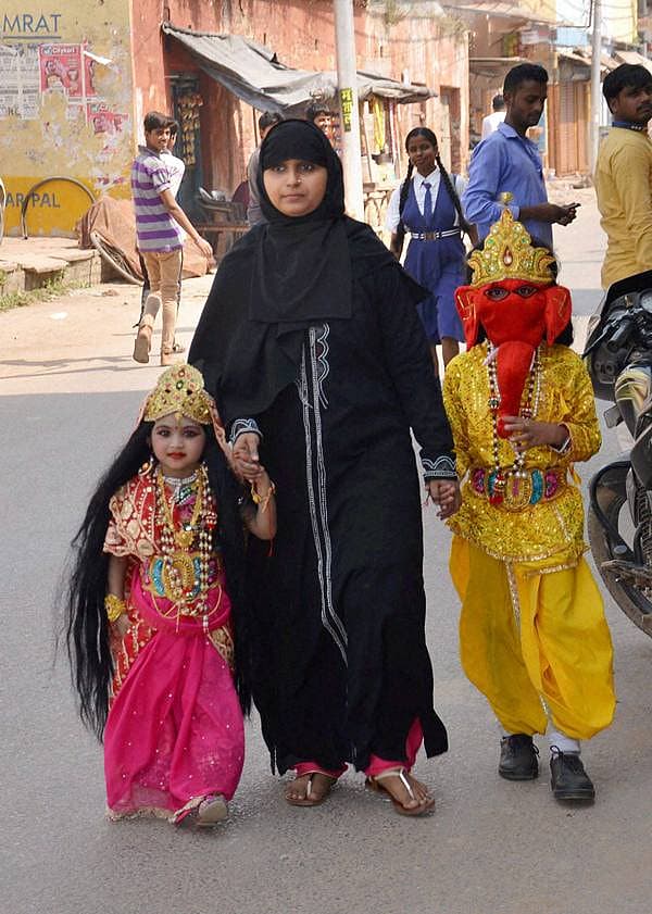 <b>ಲಕ್ಷ್ಮೀ, ಗಣೇಶ ಬಂದ್ರು ದಾರಿ ಬಿಡಿ...</b> ಮಿರ್ಜಾಪುರದಲ್ಲಿ ಮಂಗಳವಾರ ಮುಸ್ಲಿಂ ಮಹಿಳೆಯೊಬ್ಬರು ಗಣೇಶ ಹಾಗೂ ಲಕ್ಷ್ಮೀ ವೇಶಧಾರಿ ತನ್ನ ಮಕ್ಕಳನ್ನು ದೀಪಾವಳಿ ಹಬ್ಬದ ಪ್ರಯುಕ್ತ ಅವರ ಶಾಲೆಯಲ್ಲಿ ಆಯೋಜಿಸಿದ್ದ ಕಾರ್ಯಕ್ರಮಕ್ಕೆ ಕರೆದೊಯ್ಯುತ್ತಿರುವುದು.
